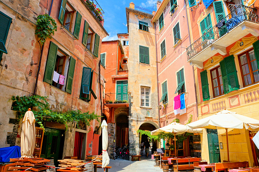 Colorful square with restaurant tables in the Cinque Terre village of Monterosso, Italy