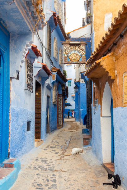 Colorful street of the Blue City with a restaurant signboard in Chefchaouen Medina, Morocco stock photo