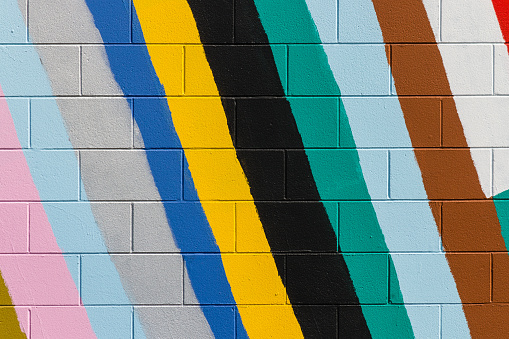 colorful stripes painted on brick wall