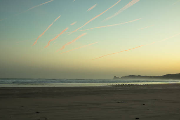 colorful sunrise sky on hendaye sandy beach, basque country, france stock photo