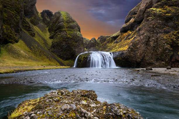 Colorful sunset at a waterfall in Iceland Long exposure of a colorful sunset in South Iceland dettifoss waterfall stock pictures, royalty-free photos & images