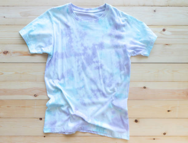 Colorful tie die tshirt on wooden background. fashion summer stock photo