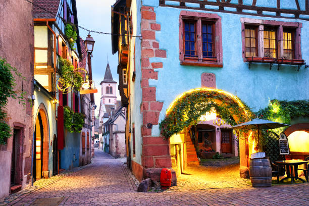 Colorful town of Riquewihr, Alsace, France Picturesque street with traditional colorful houses in Riquewihr village on alsatian wine route, Alsace, France riquewihr stock pictures, royalty-free photos & images
