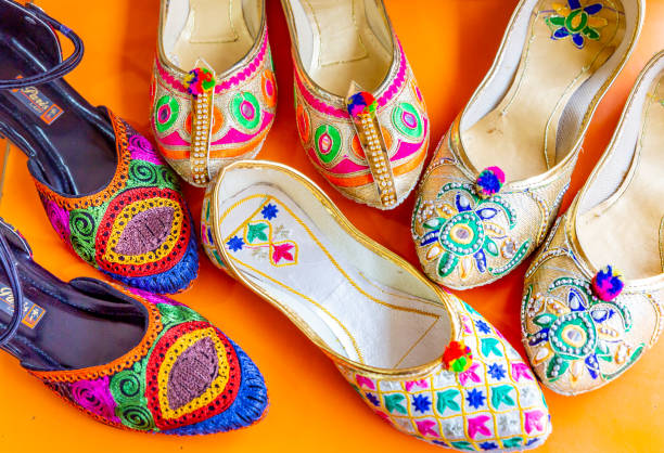 colorful Traditional  shoes in india This pic shows Numerous colorful embroidered shoes in a souvenir shop in india. The pic is taken in may 2019 and in day time. These shows are displayed in street shop in market. kota rajasthan stock pictures, royalty-free photos & images