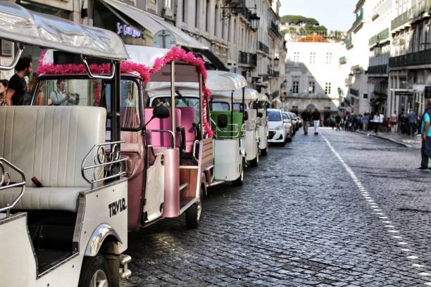 colorful tuk-tuks parked in a lisbon street - taxi lisboa imagens e fotografias de stock