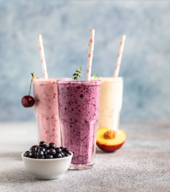 Colorful various smoothie or milkshake with assorted ingredients served in glasses with straw. Healthy food concept. stock photo