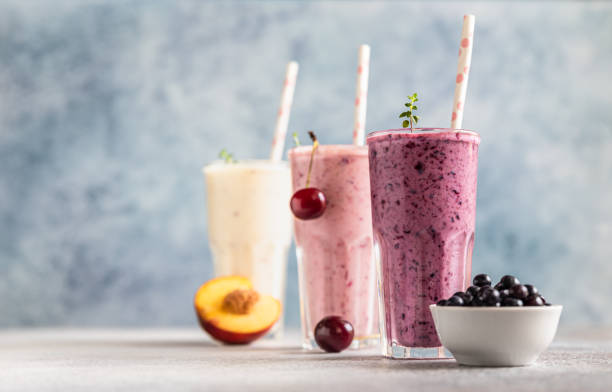 Colorful various smoothie or milkshake with assorted ingredients served in glasses with straw. Healthy food concept. stock photo