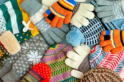 Many hats, mittens, gloves create a textural background. Warm clothes for the cold seasons.