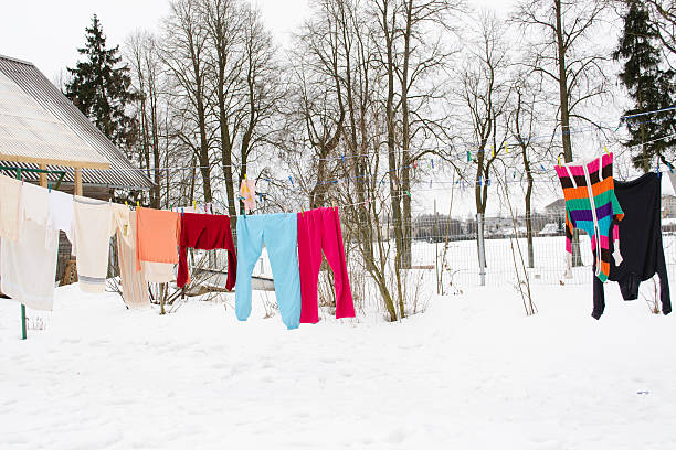colorful wash clothes loundry dry rope winter snow stock photo