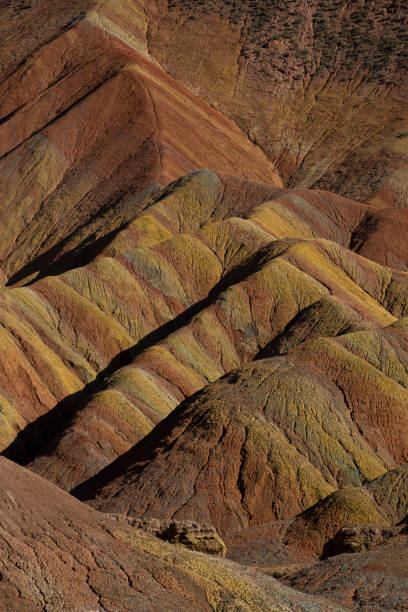 Colorful Zhangye Danxia National Geopark or China's Rainbow Mountains, Gansu, China Zhangye Danxia is known for the unusual colours of the rocks, which are smooth, sharp and several hundred meters tall. They are the result of deposits of sandstone and other minerals that occurred over 24 million years. danxia landform stock pictures, royalty-free photos & images