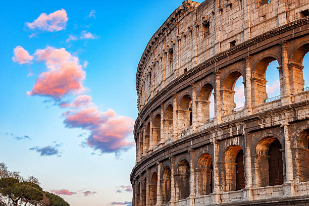 colosseum at sunset - roma stok fotoğraflar ve resimler