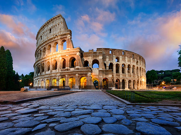Colosseum in Rome at dusk View of Colosseum in Rome and morning sun, Italy, Europe. rome italy stock pictures, royalty-free photos & images