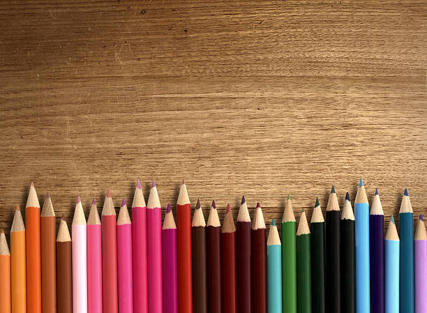 colour pencil on wood table stock photo