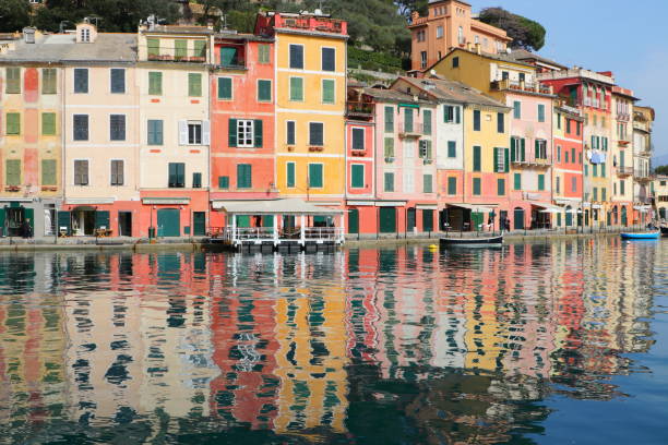 Coloured houses refleted on the water in Portofino village Liguria Italy stock photo
