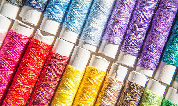 coloured sewing threads stock photo