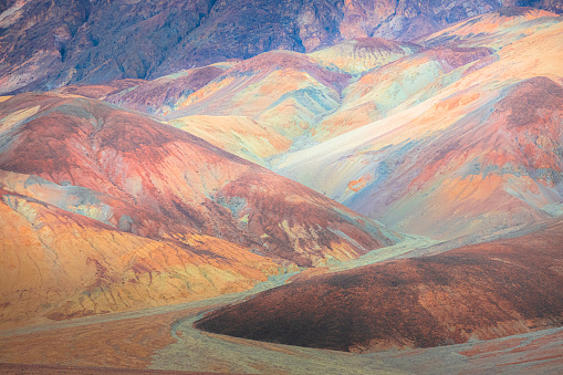 Pastel colour and  texture of the otherworldly colourful volcanic rock terrain of the badlands landscape in Death Valley Park National Park, USA.