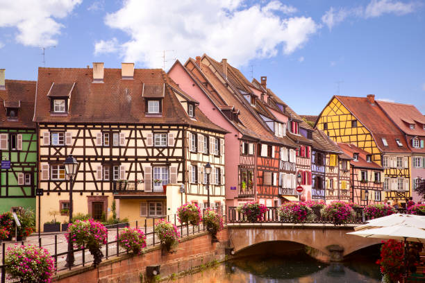 Colourful Colmar village. Picturesque view on Colmar street. Colourful architecture, canal and blue sky. Alsace, France Colmar with french traditional architecture. Historical europine town with romantic small streets known as Petite Venice. colmar stock pictures, royalty-free photos & images