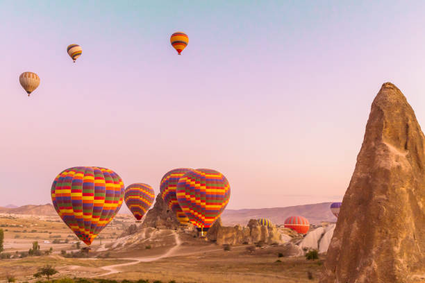 Colourful hot air balloons launching at sunrise in Cappadocia stock photo