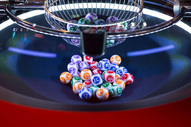 Colourful lottery balls in a machine Colourful lottery balls in a rotating bingo machine. lottery stock pictures, royalty-free photos & images