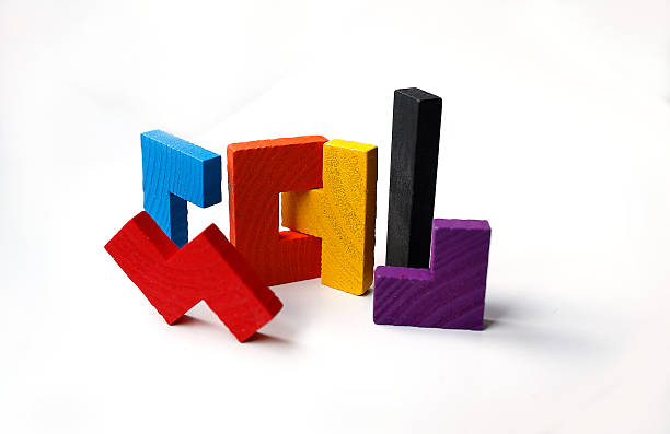 Colourful wooden puzzle blocks on white background stock photo