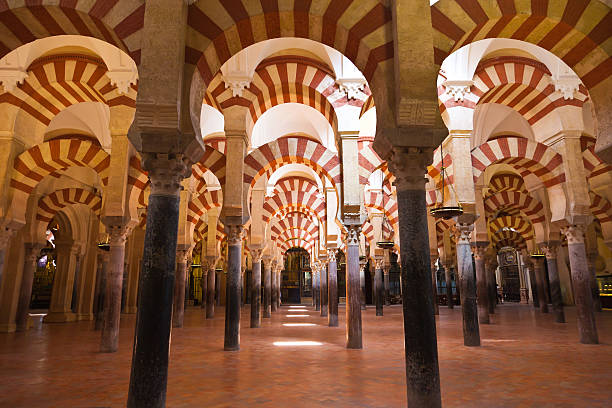 Columns forest located in Cordobas Mosque, Spain  Moorish architecture of the praying hall. The Mezquita is regarded as perhaps the most accomplished monument of the Umayyad Caliphate of Córdoba. After the Spanish Reconquista, it once again became a Roman Catholic church. cordoba spain stock pictures, royalty-free photos & images