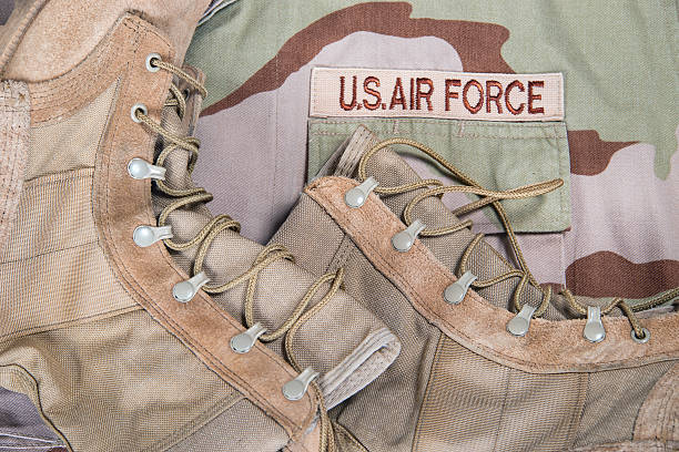 Combat boots and Air Force desert uniform Old combat boots against US Air Force camouflage desert uniform us air force stock pictures, royalty-free photos & images
