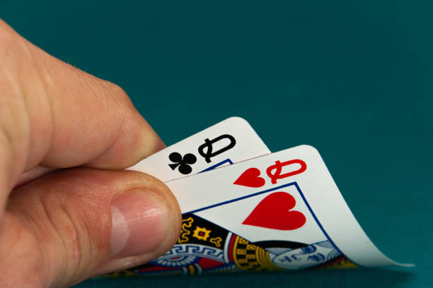 combination of two different play cards in a hand stock photo