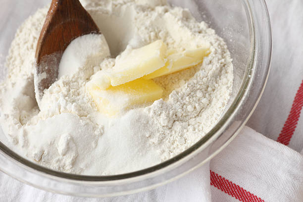 Combining butter with flour and sugar stock photo