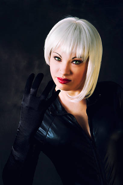 Comics Style Superhero Concept Comics Style Superhero Concept. Woman with platinum hair holding a gun 

A Beautiful young woman dressed in comic style superhero or supervillain costume white hair young woman stock pictures, royalty-free photos & images