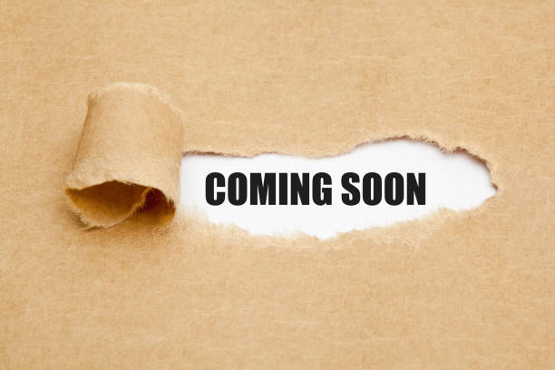Coming Soon Ripped Paper Concept The phrase Coming Soon appearing behind ripped brown paper. Concept about upcoming promising event approaching in near future. opening photos stock pictures, royalty-free photos & images