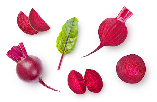 Ripe whole and sliced beetroot isolated on white background. High angle view.