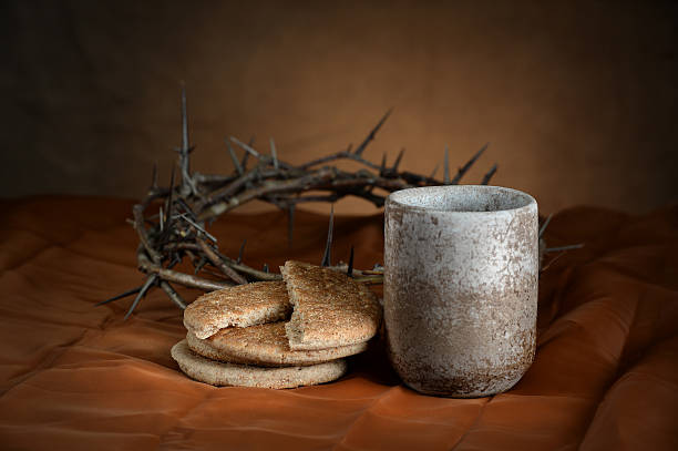 Communion Cup and Bread Communion cup and bread with crown of thorns in background communion photos stock pictures, royalty-free photos & images
