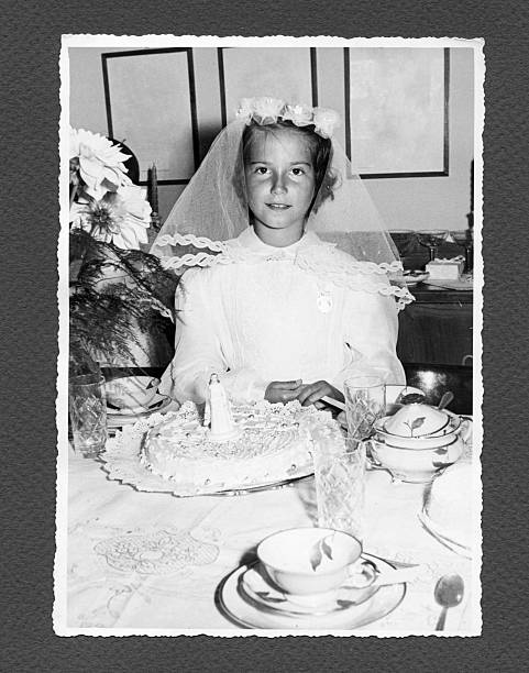 Communion in 1958 Girl with cake on Communion day. Some scratches and grain. Scanned print. communion photos stock pictures, royalty-free photos & images