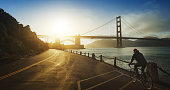istock Commuter with road racing bicycle and Golden Gate Bridge 1034402382