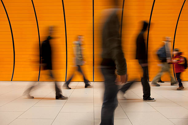 commuters against modern orange background stock photo