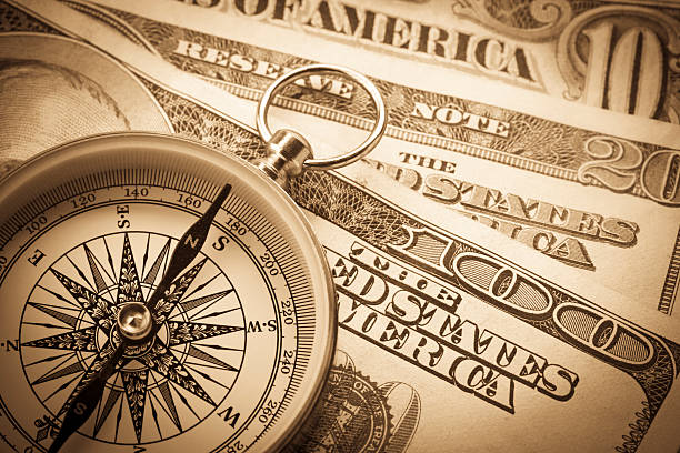 Compass and dollar stock photo