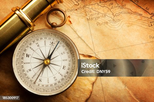 istock Compass And Spyglass On A Map 185300917