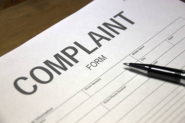 Complaint document Someone filling out a complaint registration form. complaining stock pictures, royalty-free photos & images