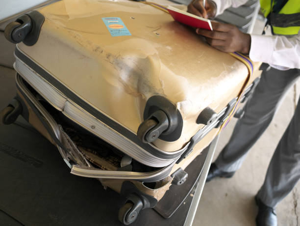 A completely broken suitcase due to poor handling at an airport Livingstone,Zambia-August 5, 2016: A completely broken suitcase due to poor handling at an airport broken suitcase stock pictures, royalty-free photos & images
