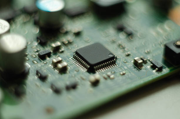 Complex electronics, green circuit board with a microcontroller stock photo