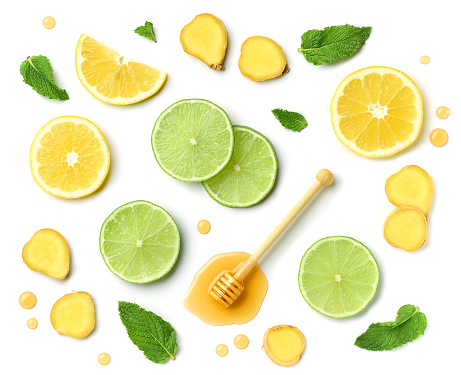 composition of honey spoon, ginger and citrus fruit slices isolated on white background, top view
