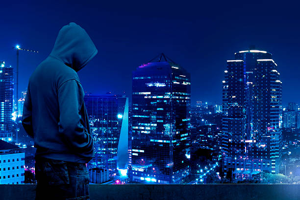 computer-hacker-silhouette-of-hooded-man-picture-id508222764