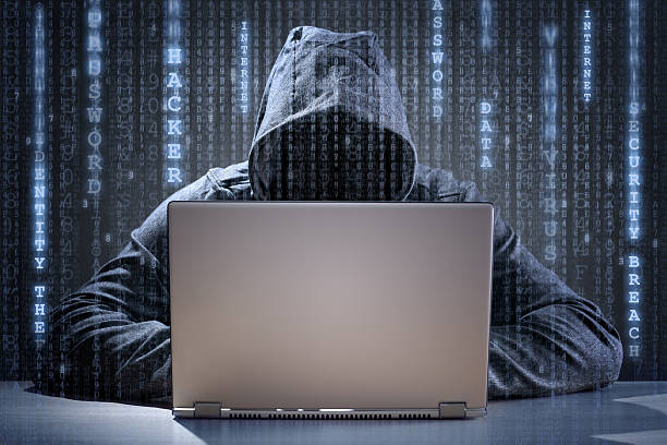 Computer hacker stealing data from a laptop Computer hacker stealing data from a laptop concept for network security, identity theft and computer crime threats stock pictures, royalty-free photos & images