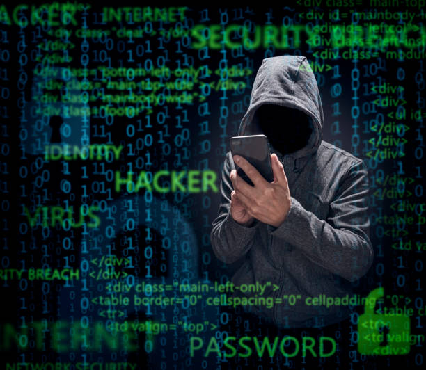 Computer hacker with mobile phone stealing data stock photo