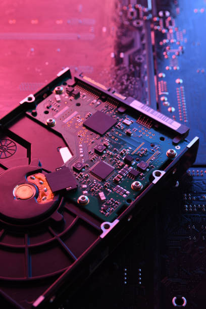 Computer Hard disk drives HDD , SSD on circuit board ,motherboard background. Close-up. With red-blue lighting Computer Hard disk drives HDD , SSD on circuit board ,motherboard background. Close-up. With red-blue lighting hard drive stock pictures, royalty-free photos & images
