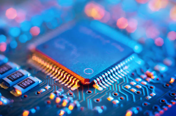 Computer Microchips and Processors on Electronic circuit board. Abstract technology microelectronics concept background. Macro shot, shallow focus. stock photo