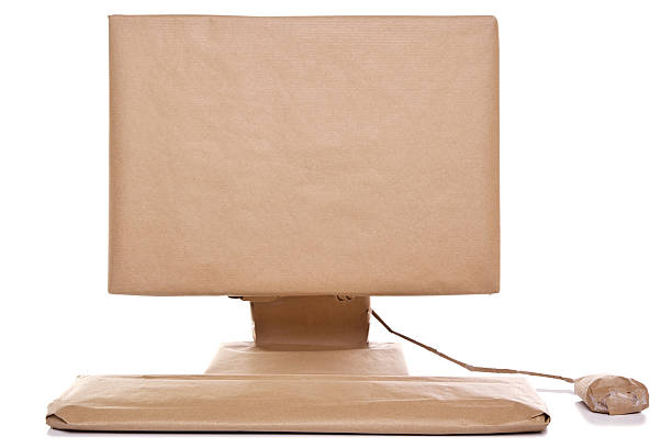 Computer wrapped in brown paper stock photo