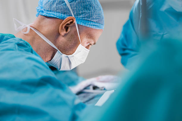 Concentrated surgeon working in operating room stock photo
