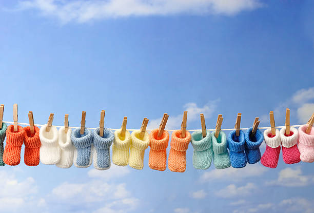 concept: baby booties in a row on clothes line stock photo
