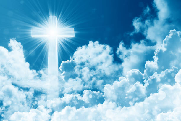 Concept of christian religion shining cross on the background of cloudy sky. Sky with cross and beautiful cloud. Divine shining heaven, light. Peaceful religious background stock photo
